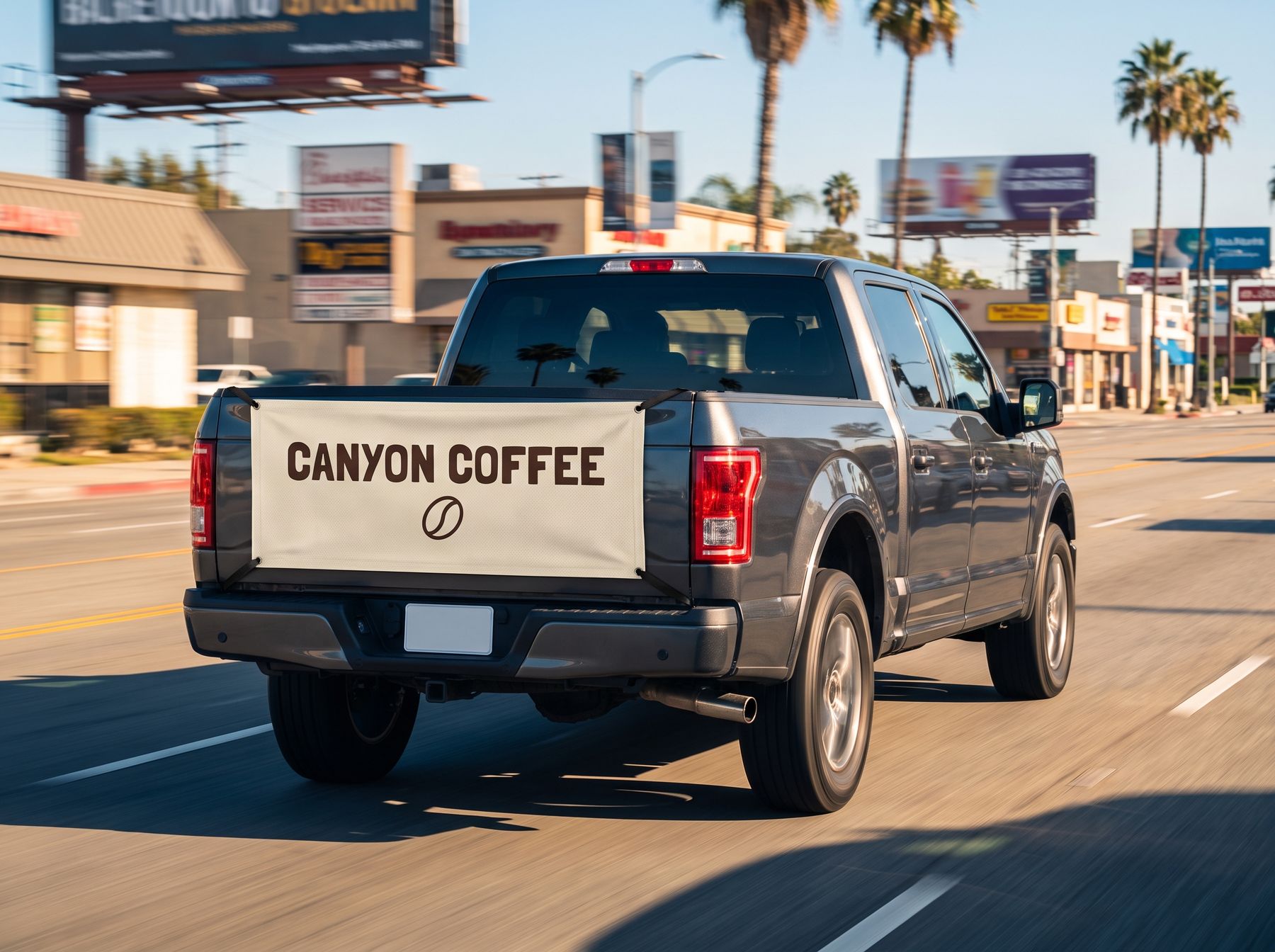 Driver fitting an advertising cover over a pickup tailgate